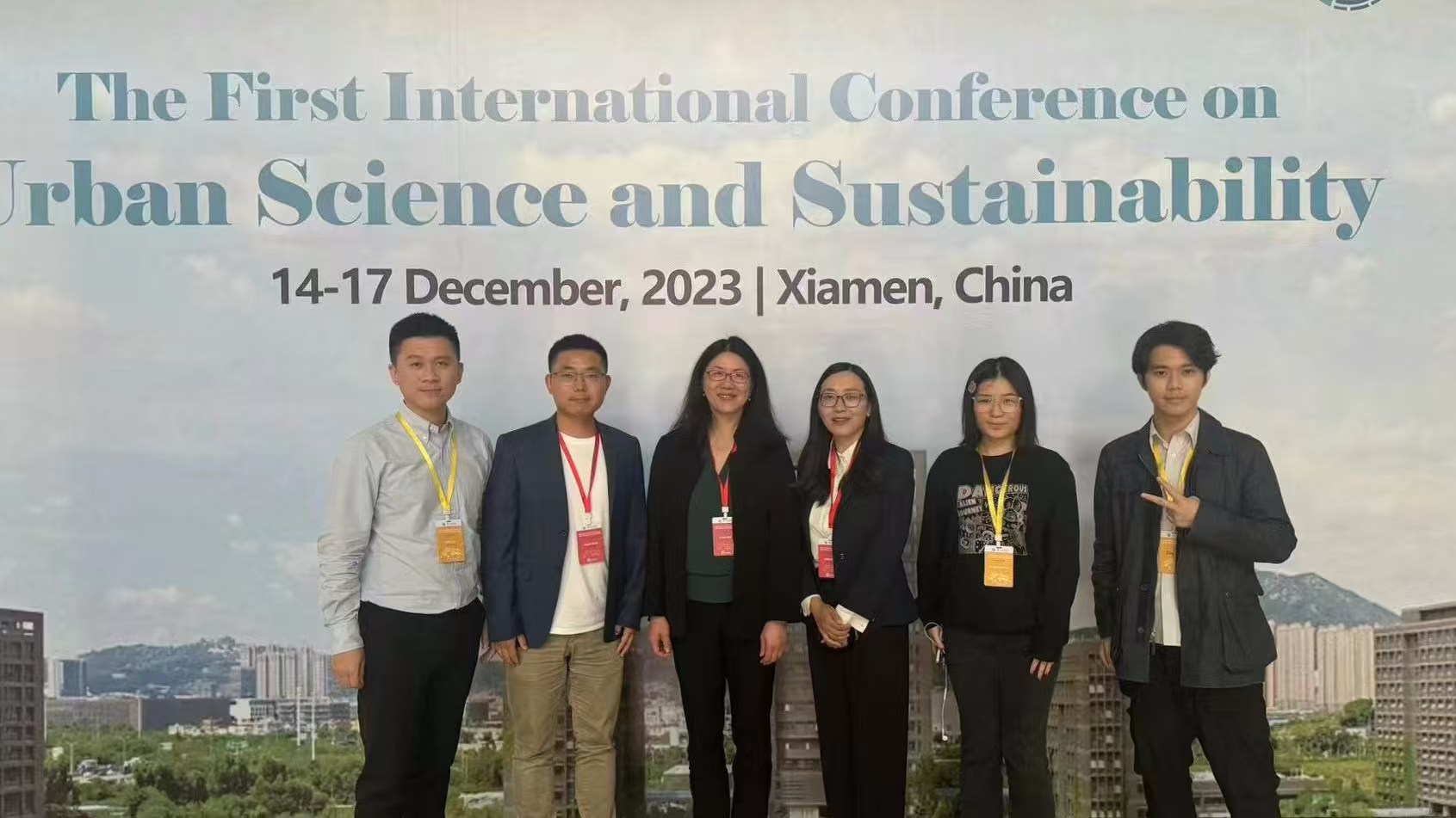 Group photo in front of the USS conference poster.