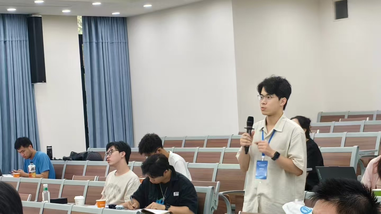 Yilong Wu speaking with a microphone after the report.