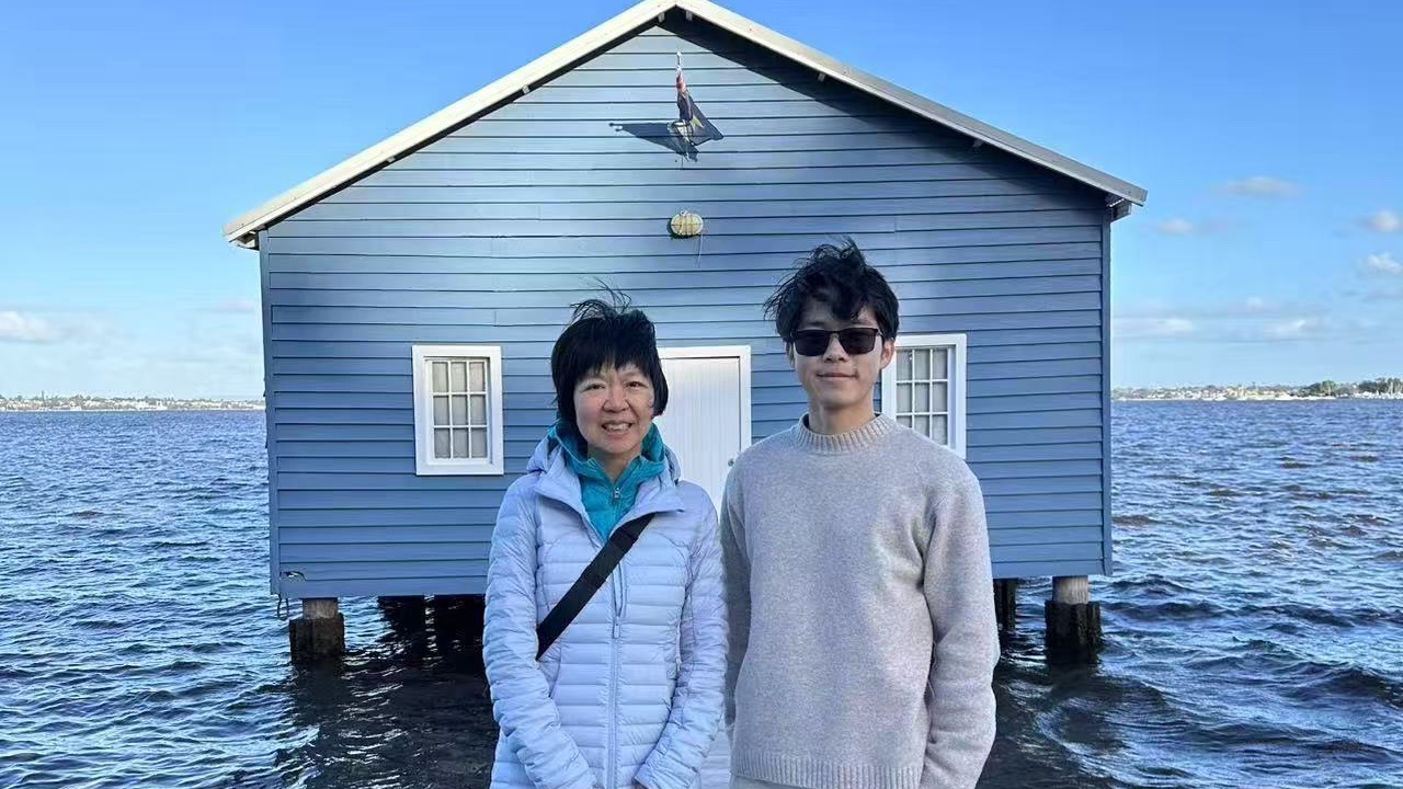 Yilong Wu and Prof. Xin Wang in front of the Blue Boat House in Perth.