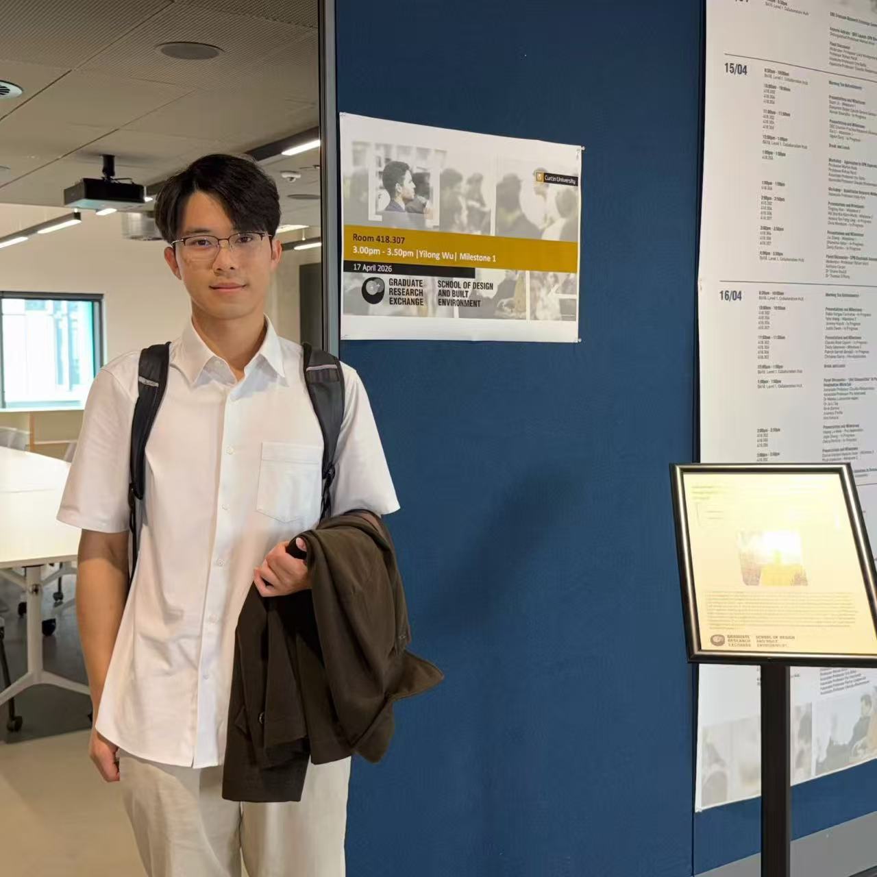 Yilong Wu outside Room 418.307 before his PhD Milestone 1 presentation at Curtin University.